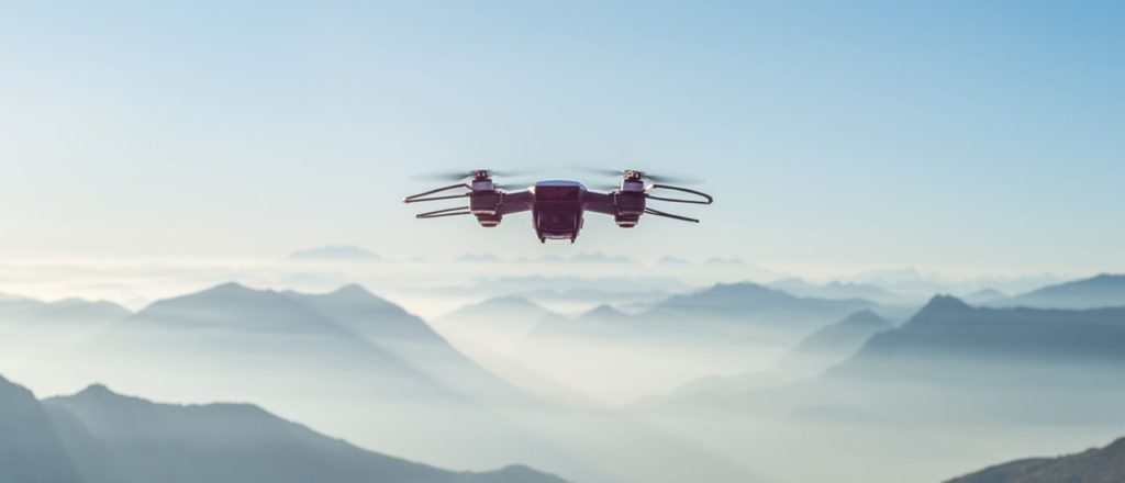 Drone flying in front of a mountain range