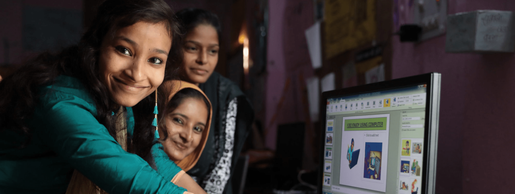 Young women around a computer in Patna, Bihar, India