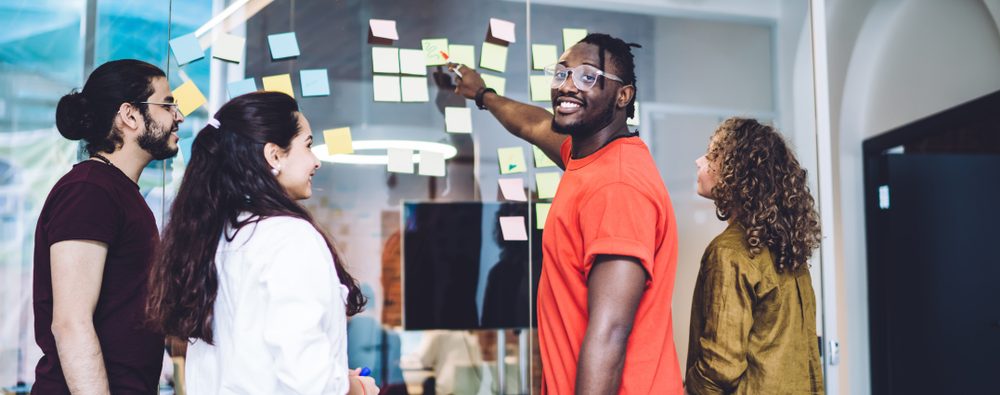 group of people using sticky notes in a meeting