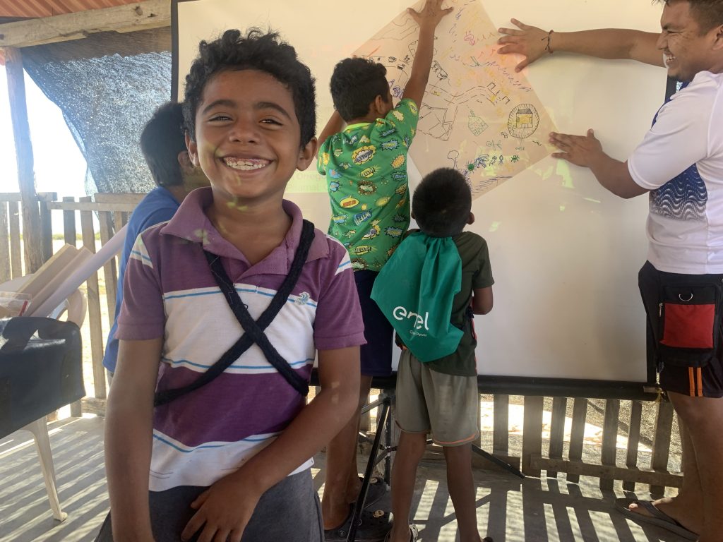 Children hanging up a poster