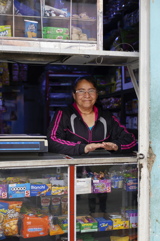 A shopkeeper looking out over her counter