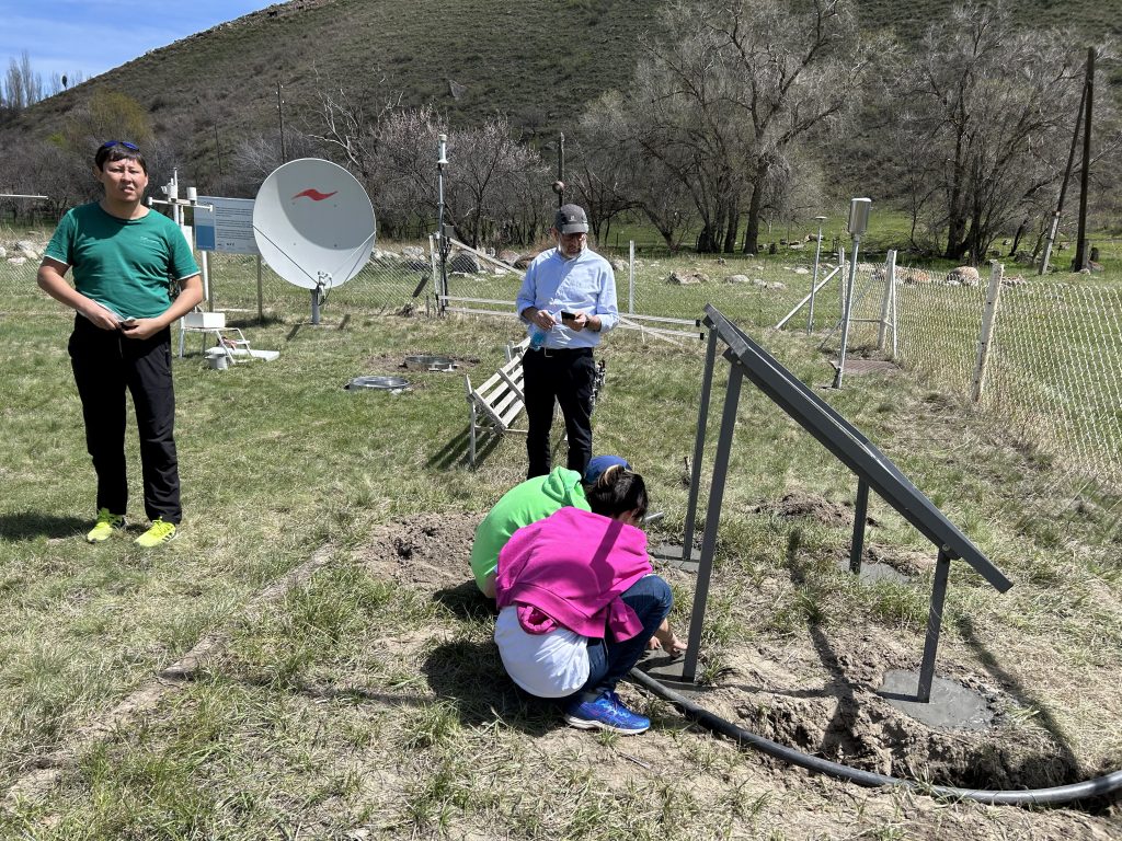 Project team members setting wireless sensors in the field in Kyrgyz Republic