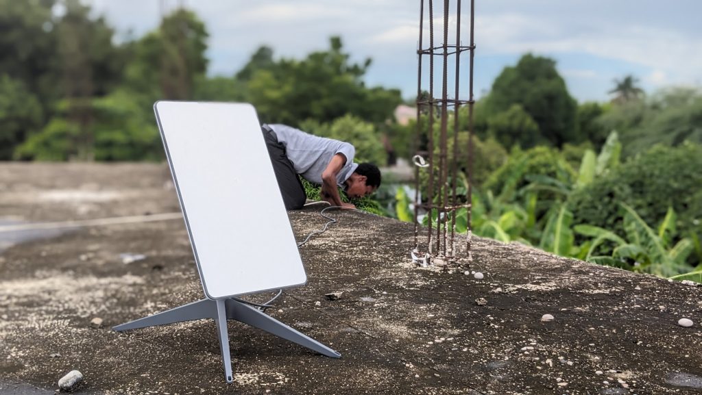Man installing internet connection antenna