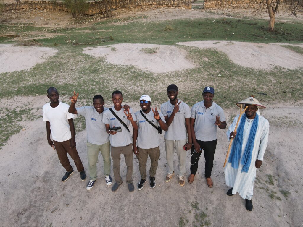 A group of African men pausing for a photo in a community in Senegal.