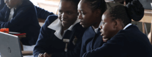 3 young students working at a computer.