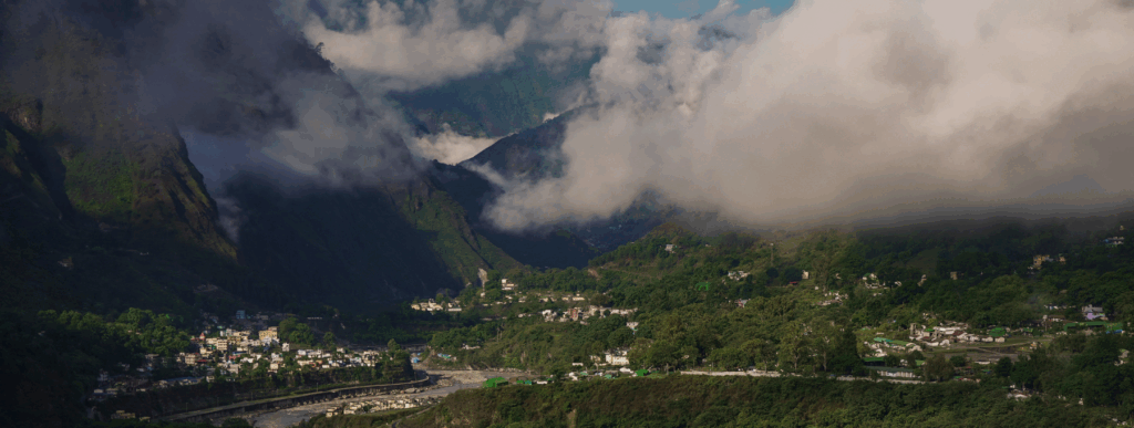 A valley with cloudy mountains.