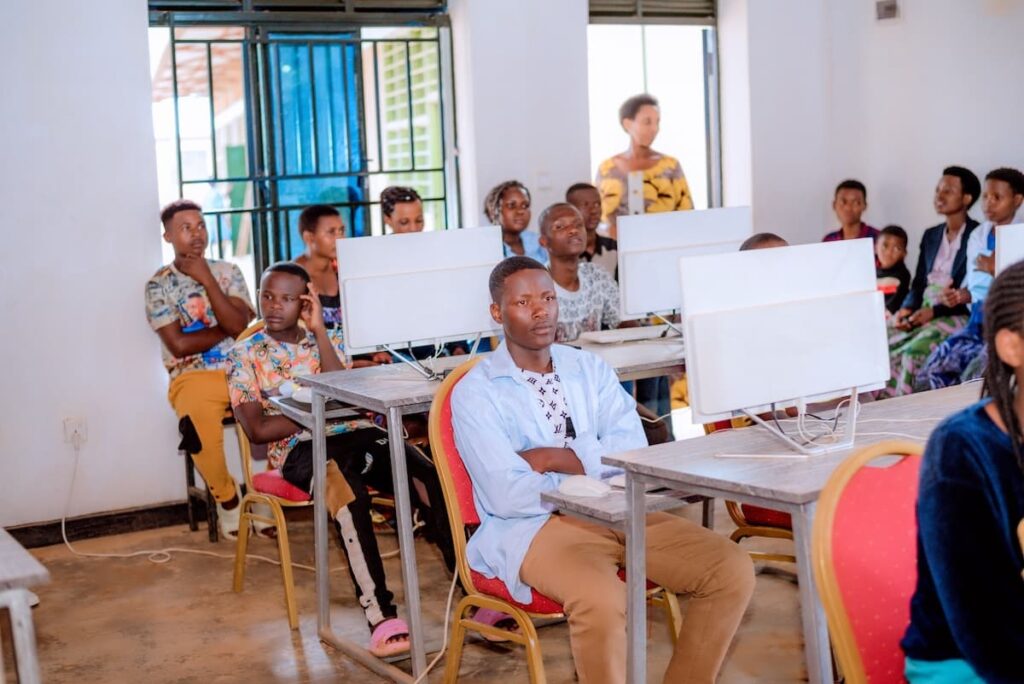 A group of individuals seated at desks, working on computers