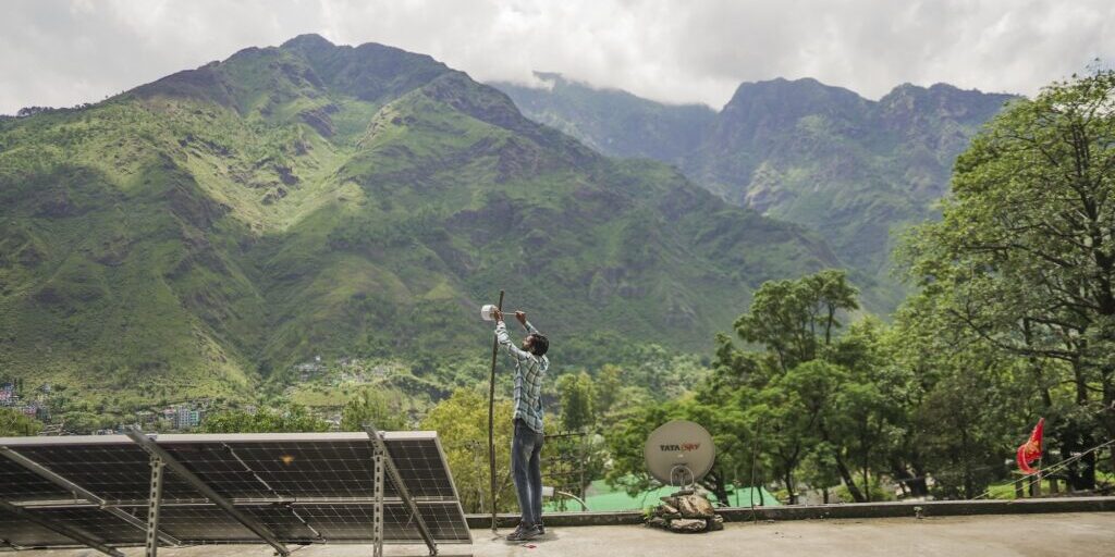 A man assembles an Internet device in a mountain.