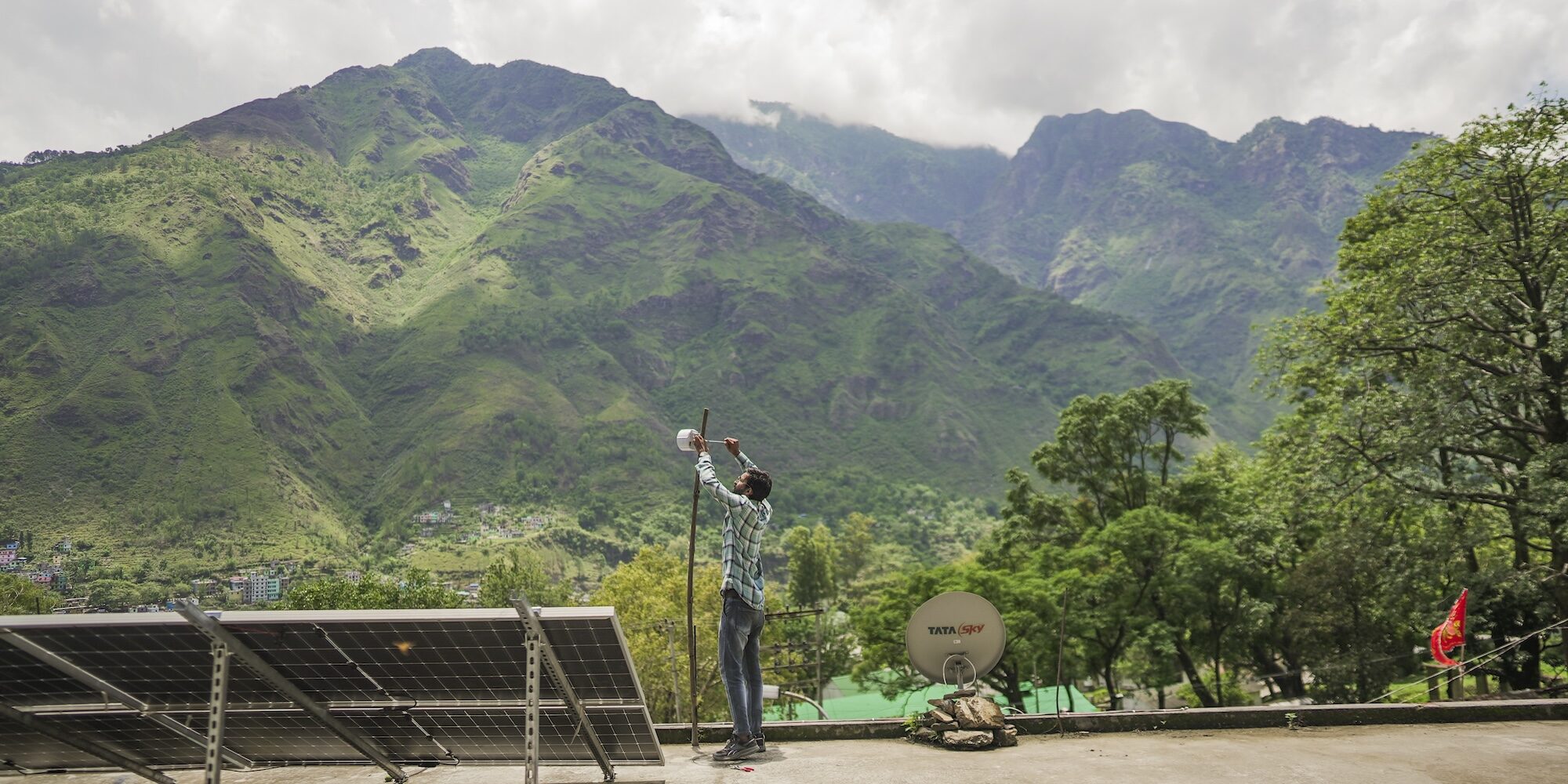 A man assembles an Internet device in a mountain.