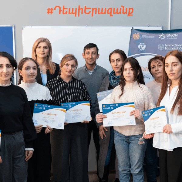 A group of students showing their certificates.