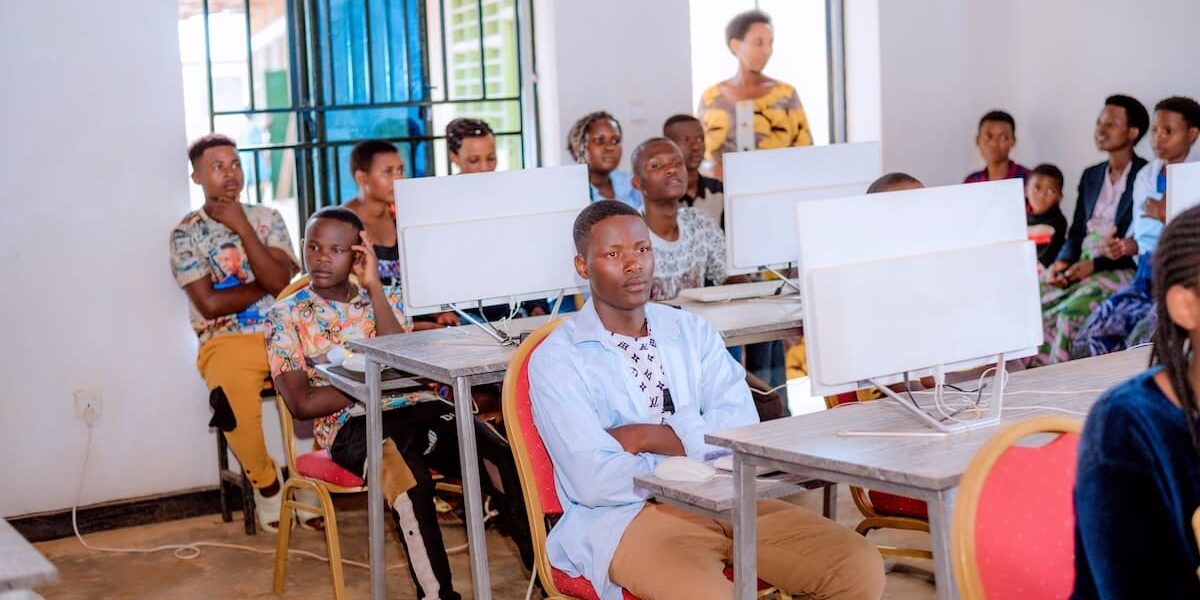 A group of individuals seated at desks, working on computers