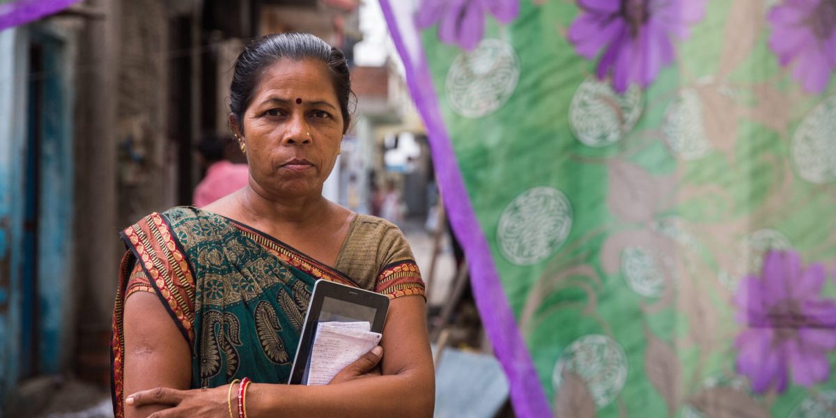 Narmada Ben, an informal worker, carries out important surveys in her neighbourhood slum. She upgraded her skills by attending trainings through the Self Employed Women's Association (SEWA), a trade union for poor, self-employed women in the informal sector, and Mahila Housing Trust (MHT) a NGO that improves the housing conditions of poor, informally employed women. She now earns 180 rupees a day by surveying electricity output in her area using tablet technology, and has helped conduct a city development survey.