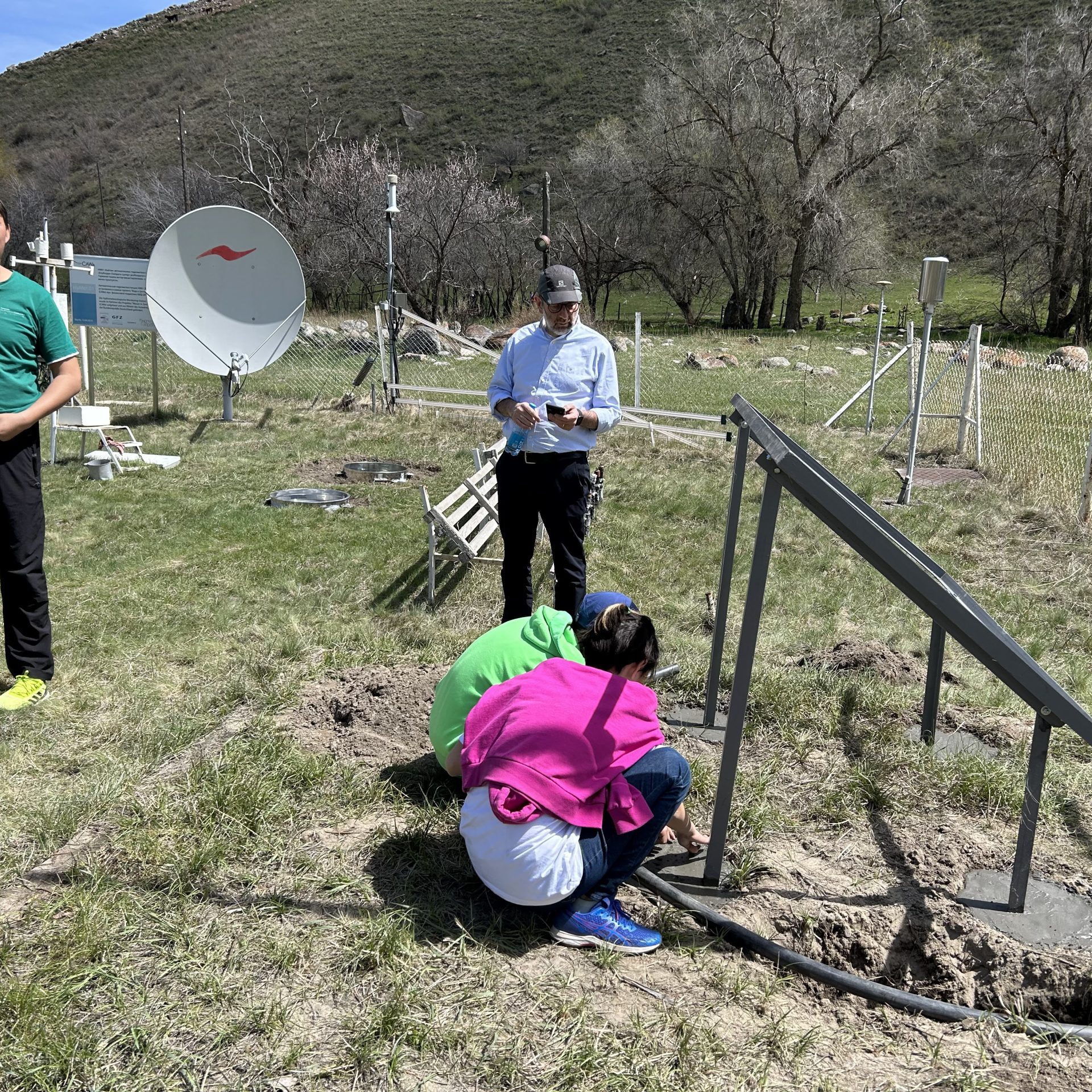 Project team members setting wireless sensors in the field in Kyrgyz Republic