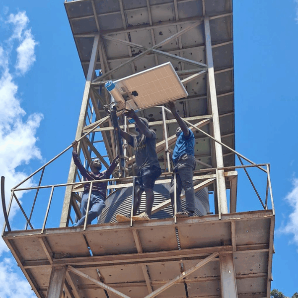 Three men in a tower are assembling Internet infrastructure.
