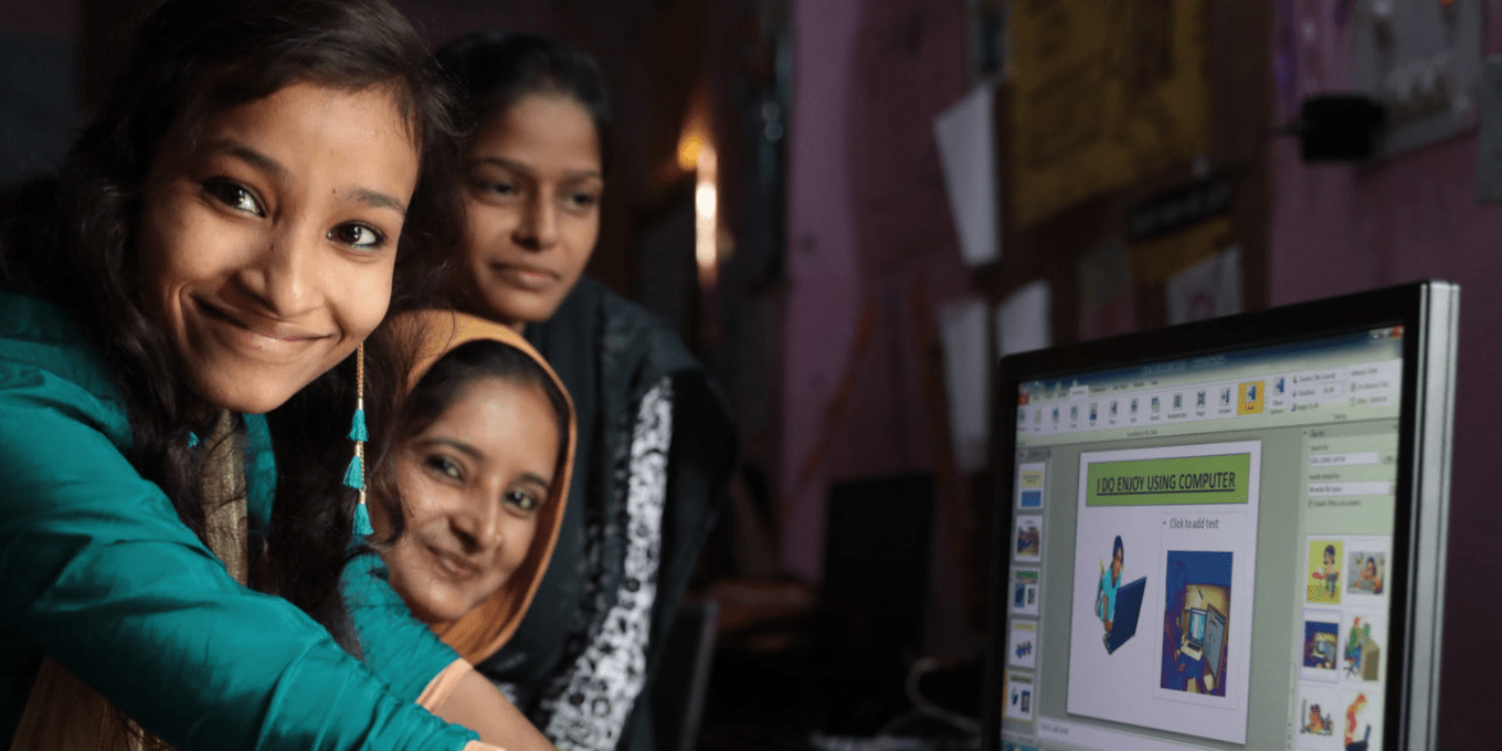 Young women around a computer in Patna, Bihar, India