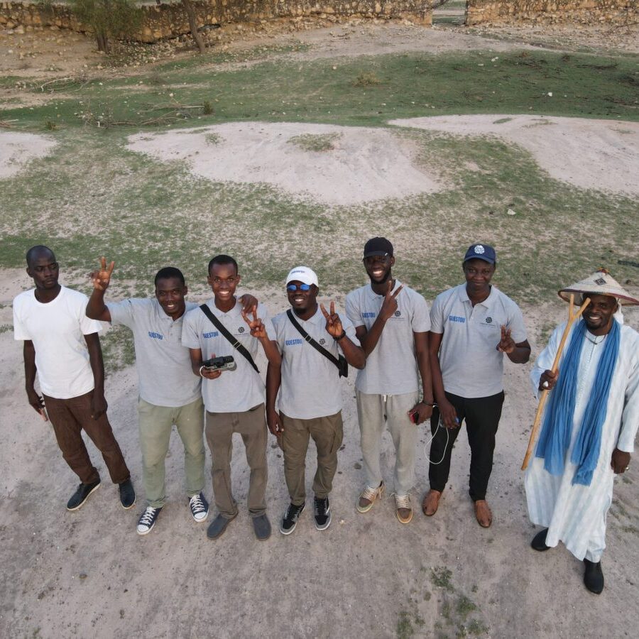A group of African men pausing for a photo in a community in Senegal.