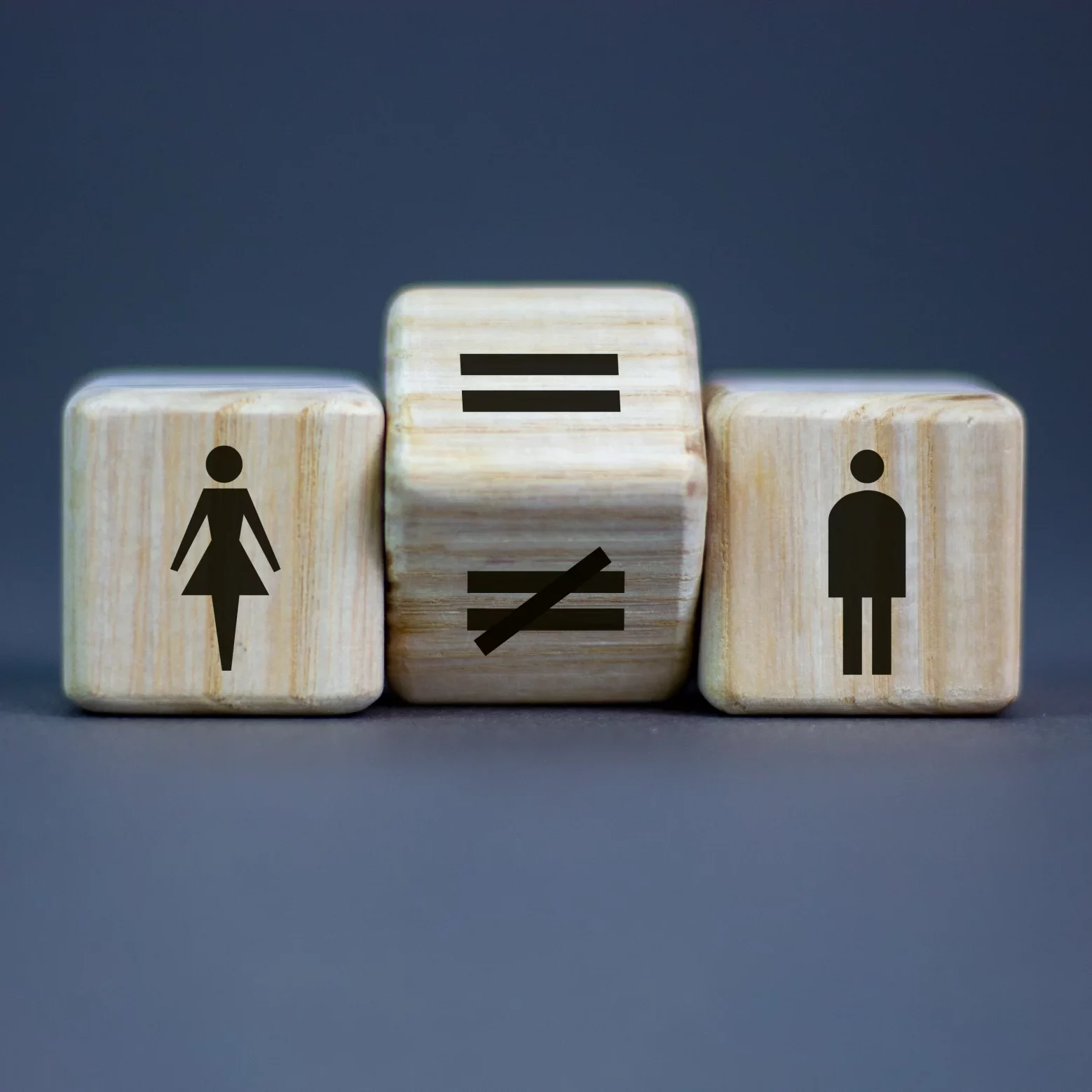 Concept photo that shows a man and a woman next to a image with the equal sign.